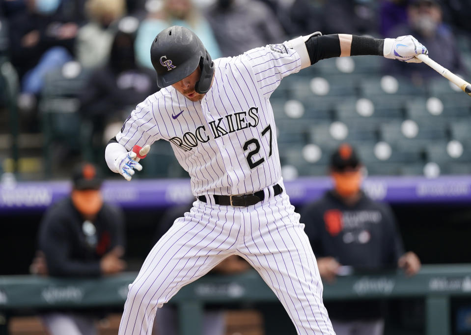 Colorado Rockies' Trevor Story reels back from inside pitch from San Francisco Giants' Logan Webb during the fourth inning of a baseball game Wednesday, May 5, 2021, in Denver. (AP Photo/David Zalubowski)