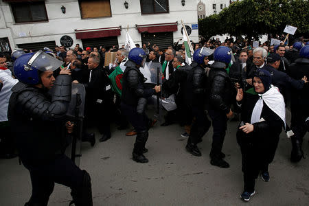 Police try to disperse lawyers marching during a protest to demand the immediate resignation of President Abdelaziz Bouteflika, in Algiers, Algeria March 23, 2019. REUTERS/Ramzi Boudina