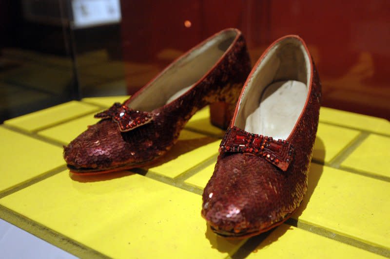 The ruby slippers worn by Judy Garland as Dorothy in "The Wizard of Oz," are on display at the National Museum of American History in Washington on November 19, 2008. On July 18, 1939, after a sneak preview of the movie, producers debated about removing one of the songs because it seemed to slow things down. The song: "Over the Rainbow." File Photo by Roger L. Wollenberg/UPI