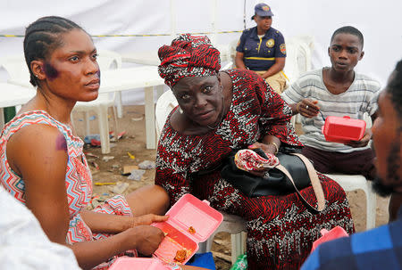 A rescued woman is pictured during counselling at the site of a collapsed building in Nigeria's commercial capital of Lagos, Nigeria March 15, 2019. REUTERS/Afolabi Sotunde