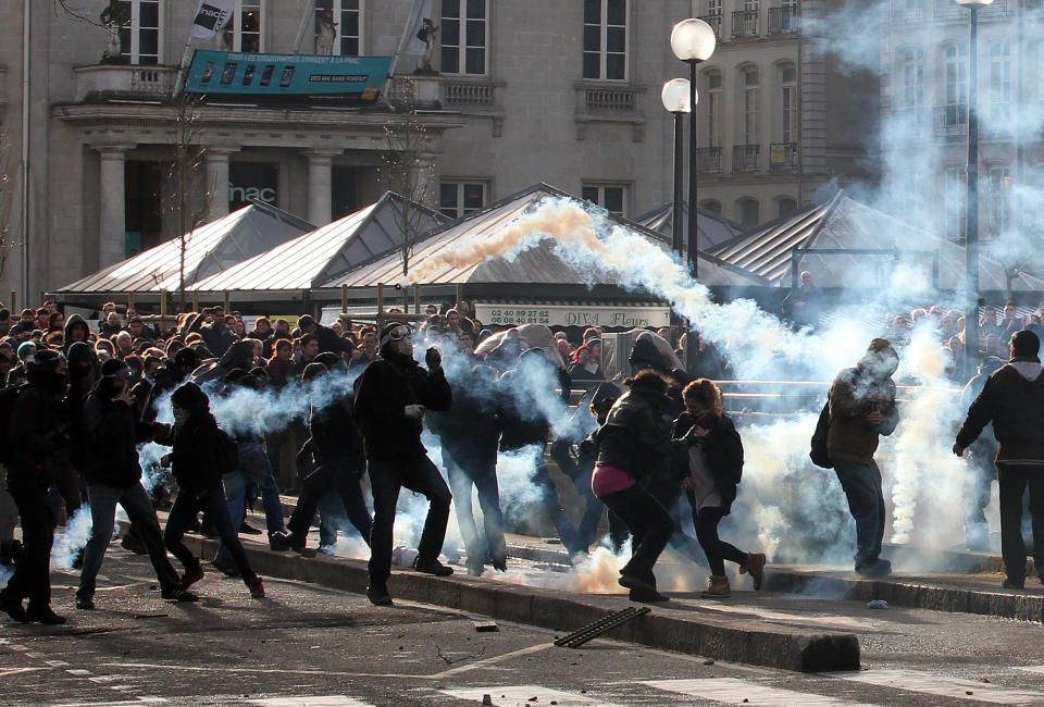 Demonstrators clash with French riot police during a demonstration in Nantes, Saturday Feb. 22, 2014, as part of a protest against a project to build an international airport, in Notre Dame des Landes, near Nantes. The project was decided in 2010 and the international airport should open by 2017. (AP Photo/ Laetitia Notarianni)