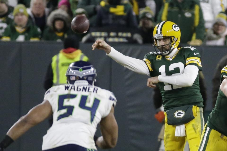 Green Bay Packers' Aaron Rodgers throws during the second half of an NFL divisional playoff football game against the Seattle Seahawks Sunday, Jan. 12, 2020, in Green Bay, Wis. (AP Photo/Mike Roemer)