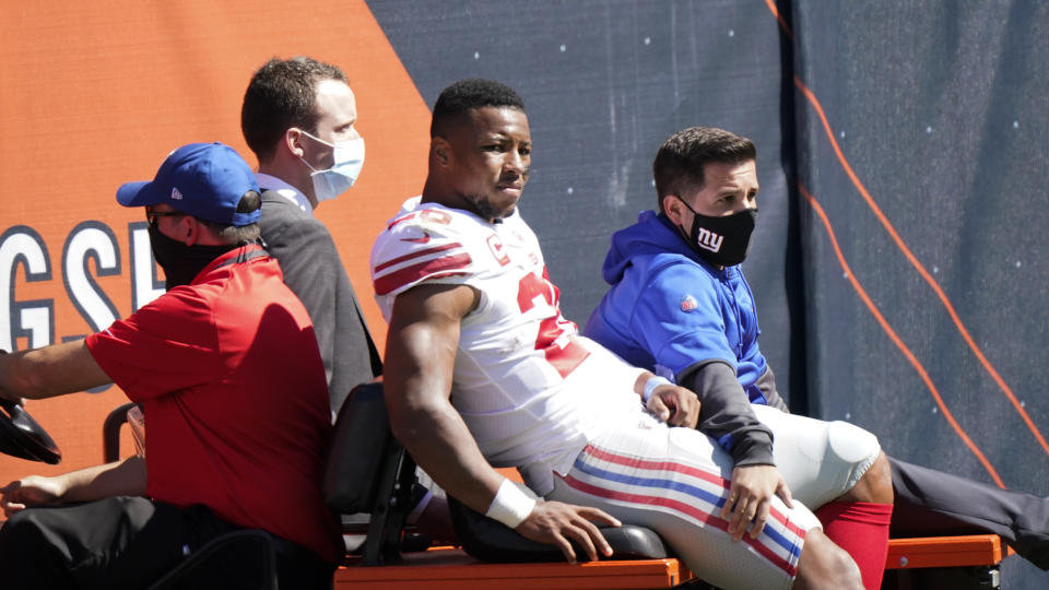 New York Giants running back Saquon Barkley (26) is carted to the locker room after being injured during the first half of an NFL football game against the Chicago Bears in Chicago, Sunday, Sept. 20, 2020. (AP Photo/Nam Y. Huh)