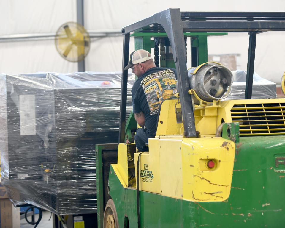 Chris Smith, a driving operator with Canton Erectors, moves and places a new piece of equipment at the Seco Machine factory in Green. Canton Erectors is one of seven companies receiving the Business Excellence Award this Thursday from the Canton Regional Chamber of Commerce.