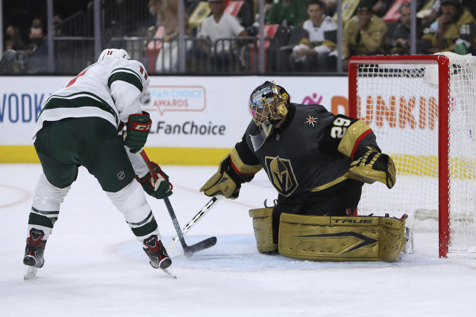 Vegas Golden Knights goalie Marc-Andre Fleury (29) makes a save against Minnesota Wild left wing Zach Parise (11) during the first period of Game 7 of an NHL hockey Stanley Cup first-round playoff series Friday, May 28, 2021, in Las Vegas. (AP Photo/Joe Buglewicz)