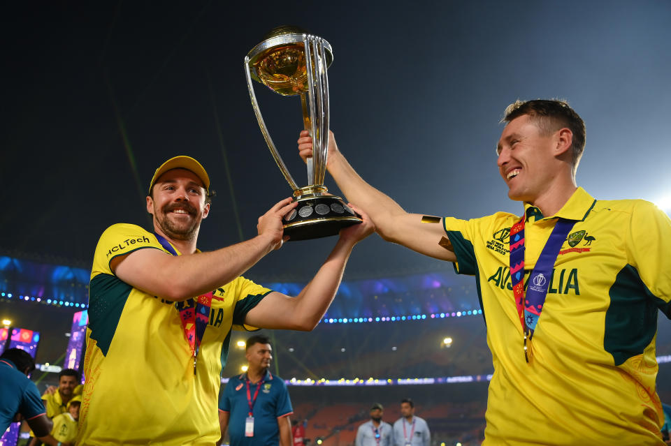 AHMEDABAD, INDIA - NOVEMBER 19: Travis Head and Marnus Labuschagne of Australia poses with the ICC Men's Cricket World Cup Trophy following the ICC Men's Cricket World Cup India 2023 Final between India and Australia at Narendra Modi Stadium on November 19, 2023 in Ahmedabad, India. (Photo by Alex Davidson-ICC/ICC via Getty Images)