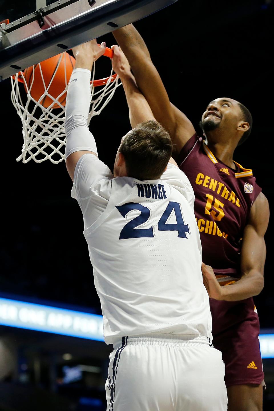 Xavier Musketeers forward Jack Nunge (24) dunks past Central Michigan Chippewas forward Aundre Polk (15) in the first half of the NCAA basketball game between the Xavier Musketeers and the Central Michigan Chippewas at the Cintas Center in Cincinnati on Wednesday, Dec. 1, 2021. Xavier led 41-25 at halftime. 