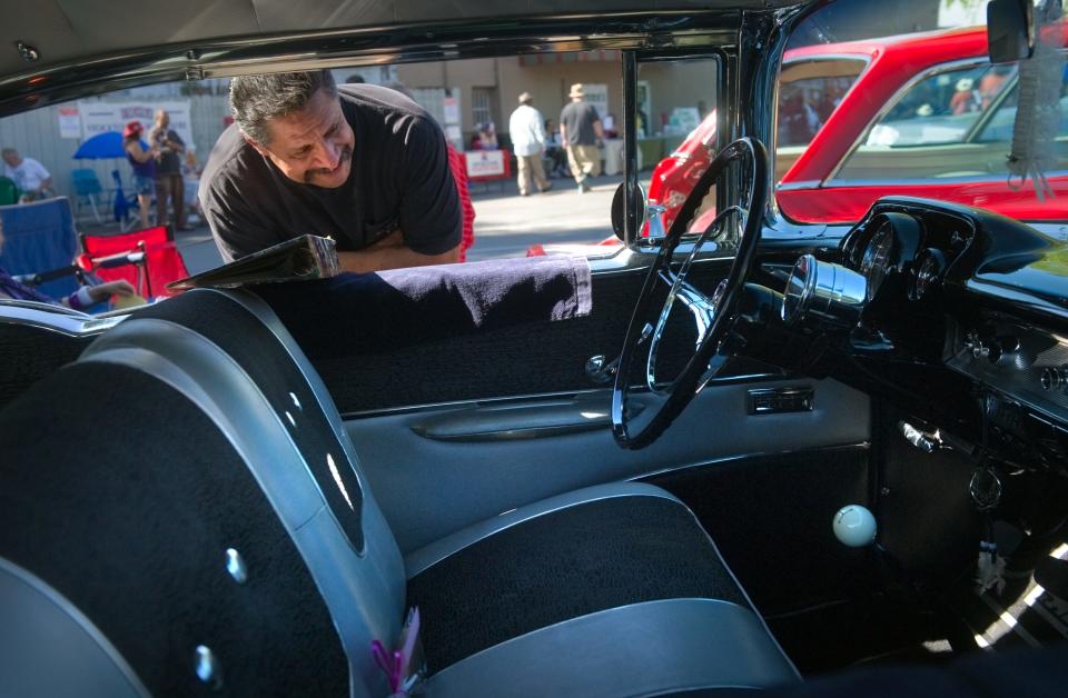 20111015 Tony Arias of Stockton takes a look at a 1957 Chevrolet Bel Air's interior at the car show at the Miracle Mile's 90th birthday celebration in Stockton.