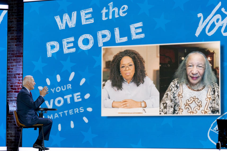 Democratic presidential candidate former Vice President Joe Biden speaks with Mildred Madison, 94, right, on a "Zoom with Oprah Winfrey" virtual show at The Queen theater in Wilmington, Del., Wednesday, Oct. 28, 2020. Madison traveled 300 Miles from the Chicago area to Detroit to make sure her vote counted for Joe Biden. (AP Photo/Andrew Harnik)