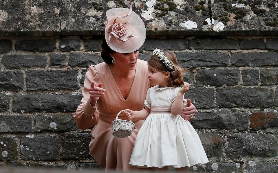 Duchess of Cambridge, stands with her daughter Princess Charlotte - Credit: REUTERS