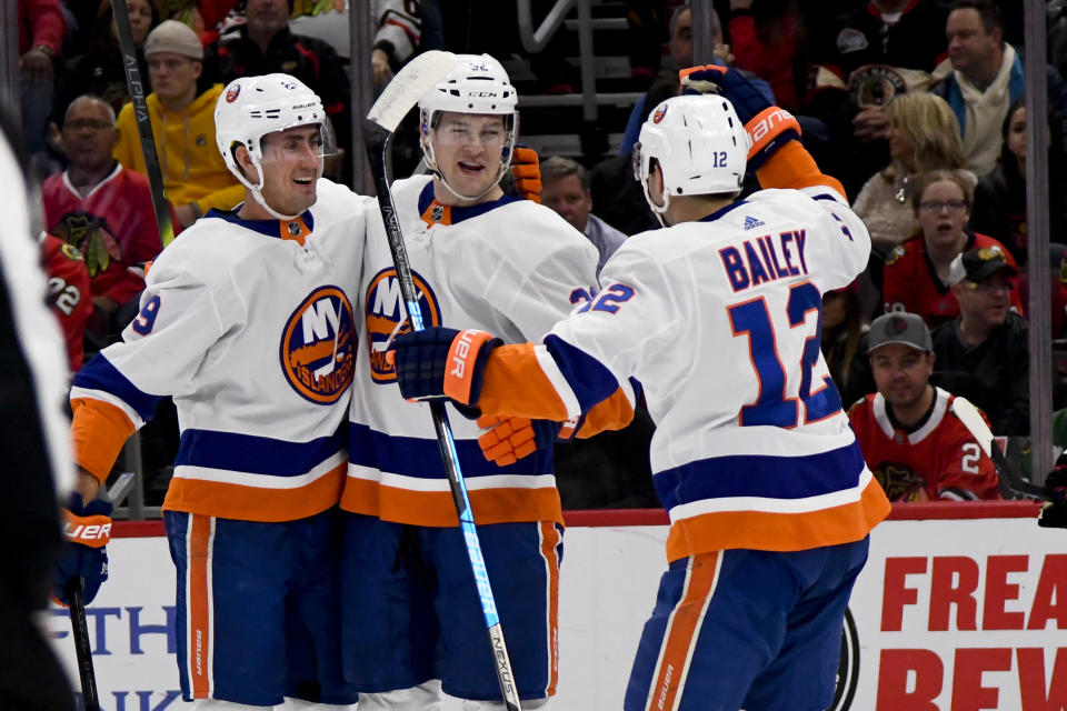 New York Islanders left wing Ross Johnston (32) celebrates with center Brock Nelson (29) and right wing Josh Bailey (12) after Johnston scored against the Chicago Blackhawks during the first period of an NHL hockey game Friday, Dec. 27, 2019, in Chicago. (AP Photo/Matt Marton)