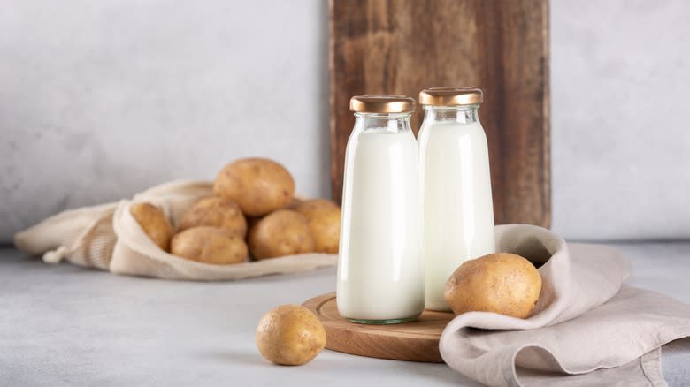 Bottled potato milk and loose potatoes