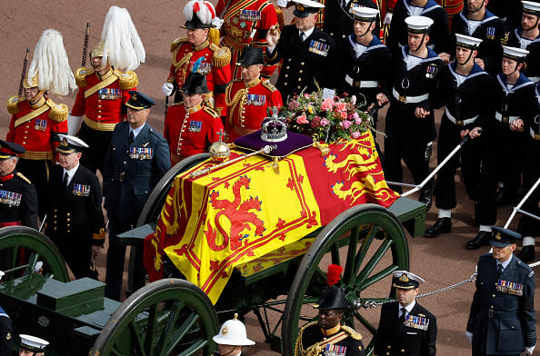 <div class="inline-image__caption"><p>The coffin of Queen Elizabeth II with the Imperial State Crown resting on top, borne on the State Gun Carriage of the Royal Navy followed by members of the royal family proceeds past Buckingham Palace on September 19, 2022 in London, England.</p></div> <div class="inline-image__credit">Chip Somodevilla/Getty Images</div>