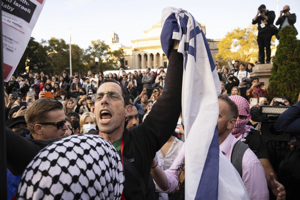 FILE - A pro-Israel demonstrator shouts at Palestinian supporters during a protest at Columbia University, Thursday, Oct. 12, 2023, in New York. As the Israel-Hamas war rages in Gaza, there's a bitter battle for public opinion flaring in the U.S., with angry rallies and disruptive protests at prominent venues in several major cities. Among the catalysts are Palestinian and Jewish-led groups that have been active for years in opposing Israeli policies toward the Palestinians. Now many groups involved in those earlier efforts are playing a key role protesting the latest fighting, with actions on campuses and beyond. (AP Photo/Yuki Iwamura, File)