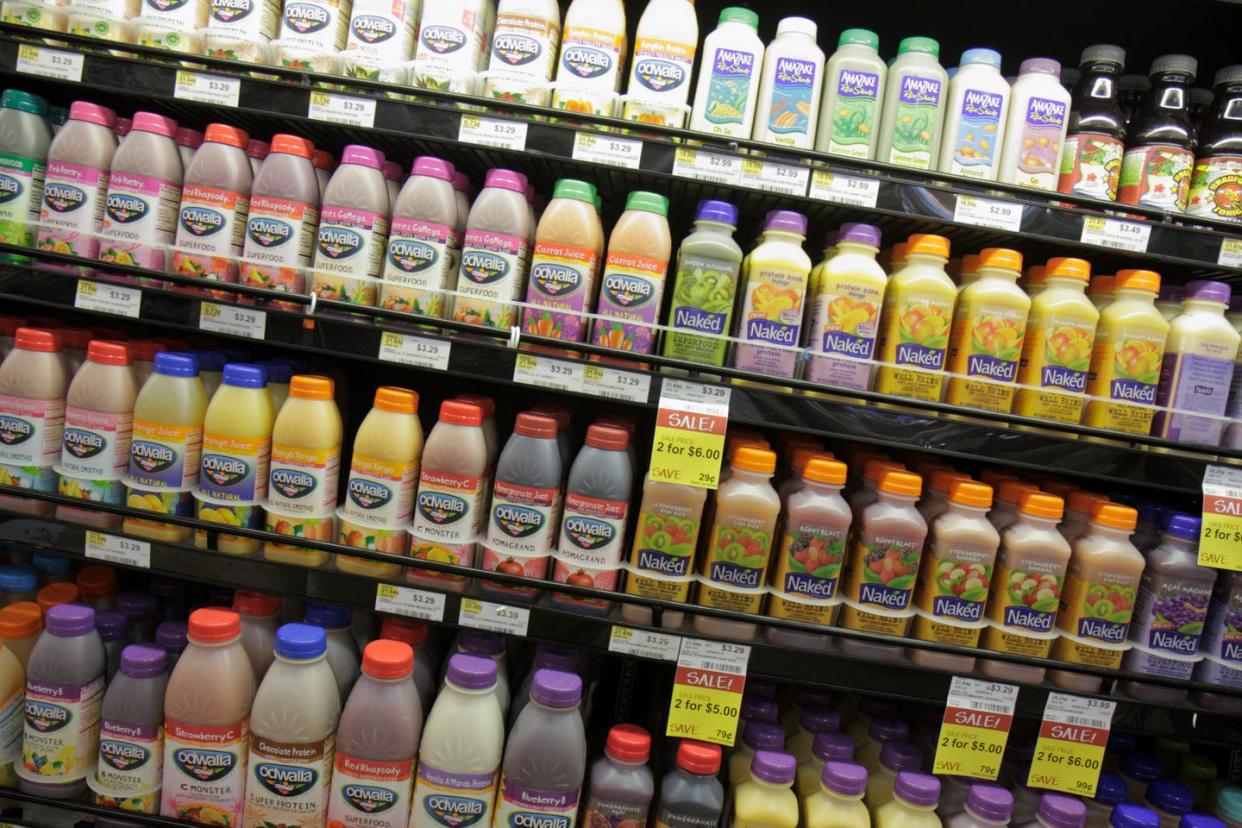 bottles of fruit juice for sale at whole foods market