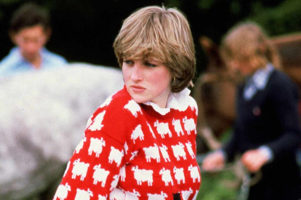 <p>Tim Graham Photo Library via Getty</p> Lady Diana Spencer in her iconic sheep sweater at Prince Charles