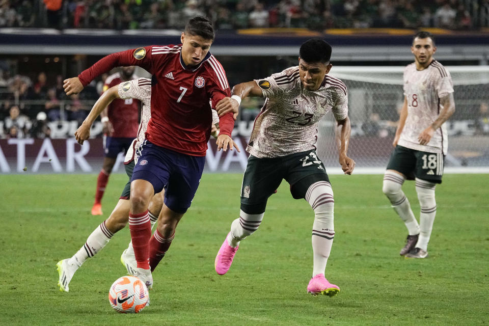 Costa Rica forward Anthony Contreras (7) controls the ball as Mexico defender Jesús Gallardo (23) defends during the first half of a CONCACAF Gold Cup soccer quarterfinal Saturday, July 8, 2023, in Arlington, Texas. (AP Photo/Sam Hodde)