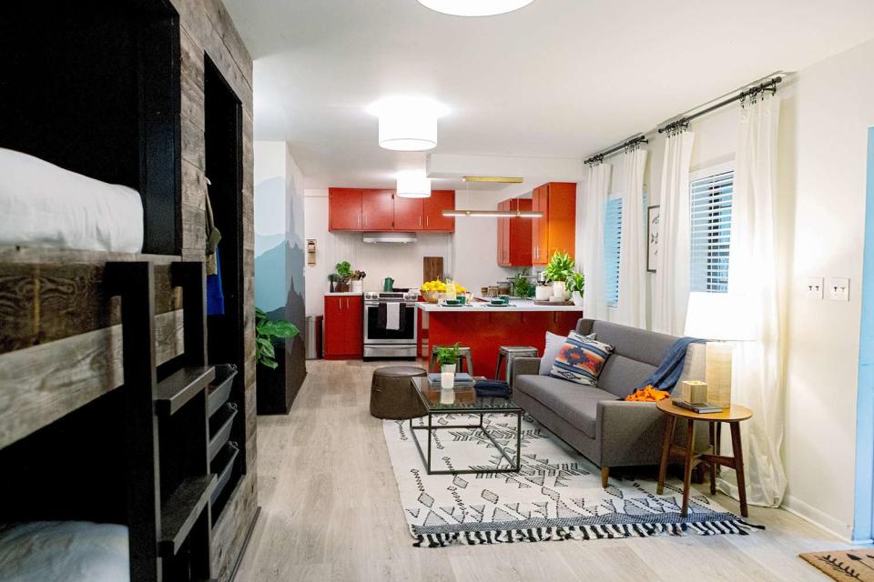 open living space with red kitchen and loft