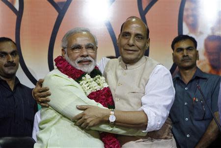 India's Hindu nationalist Narendra Modi (2nd L) hugs Rajnath Singh (2nd R), president of India's main opposition Bharatiya Janata Party (BJP), after Modi was crowned as the prime ministerial candidate for the BJP at the party headquarters in New Delhi September 13, 2013. REUTERS/Anindito Mukherjee