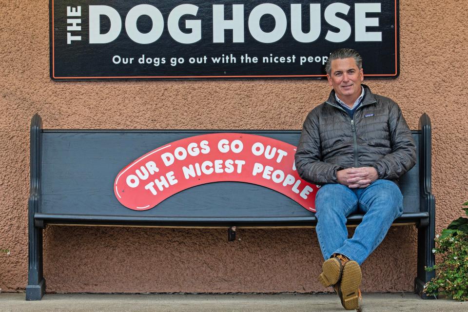 Chris Taggart, co-owner of the landmark restaurant The Dog House sits outside the eatery near New Castle, Thursday, Dec. 7, 2023. The Dog House has been serving hot dogs since 1952 and under new ownership has a new breakfast menu.