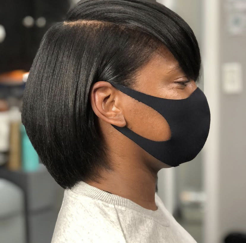 a girl in a salon chair looking to the side