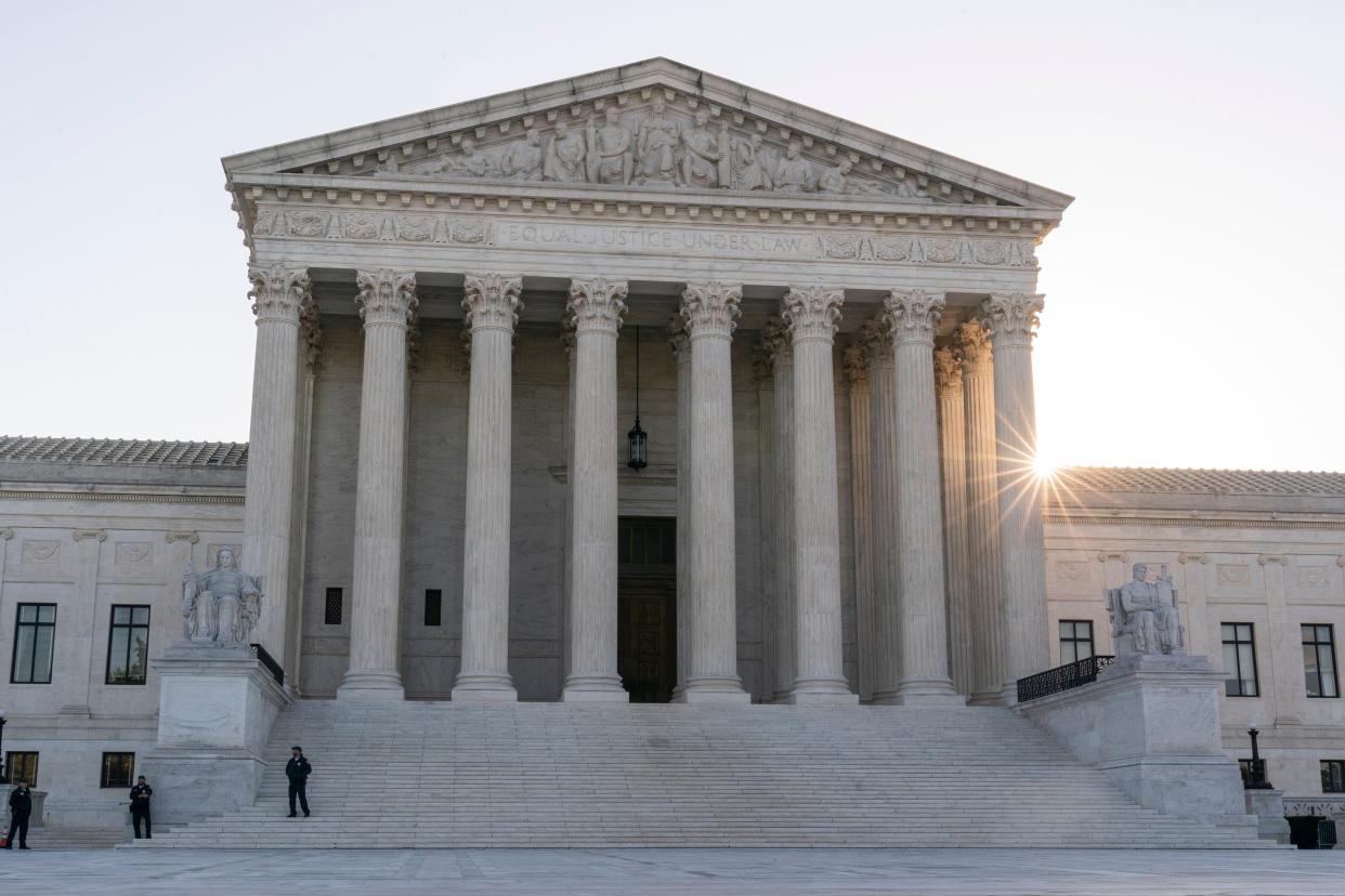 The sun rises behind the U.S. Supreme Court in Washington. Justices will begin hearing oral arguments Oct. 31 on challenges to race-conscious college admissions.