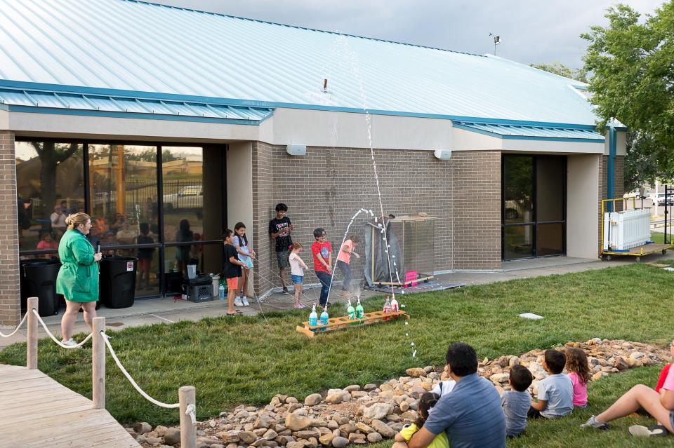 Six volunteers greet the explosion at the Don Harrington Discovery Center during the annual "Explode" event featuring science experiments that explode for the family.