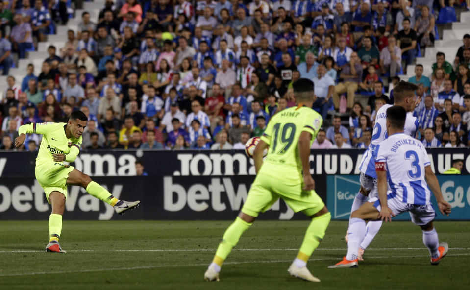 FC Barcelona's Coutinho, left, kicks the ball to score during the Spanish La Liga soccer match between Leganes and FC Barcelona at the Butarque stadium in Leganes, Spain, Wednesday, Sept. 26, 2018. (AP Photo/Manu Fernandez)