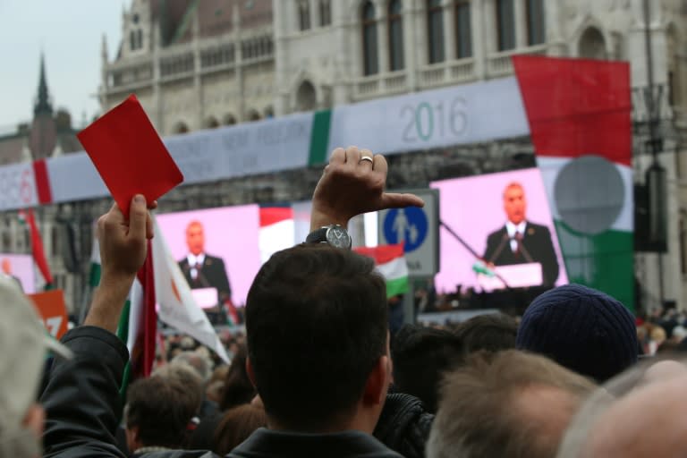 Anti-government demonstrators protest during the speech of Hungarian Prime Minister Viktor Orban in front of the Parliament in Budapest on October 23, 2016
