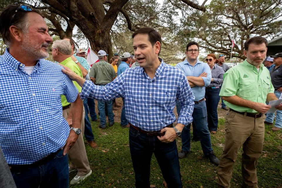 Florida Senator Marco Rubio chats with citrus grower  Kevin Koppelman , left and Matt Joyner CEO of Florida Citrus Mutual , right before the USDA crop forecast luncheon and  post-Hurricane Ian information meeting at the Putnam El Clair Ranch In Zolfo SpringsFl. Wednesday October 12,2022Ernst Peters/The Ledger