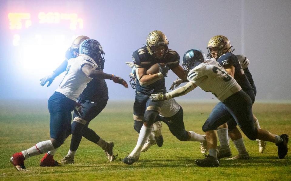 Central Catholic’s Aiden Taylor runs the ball during the CIF Division II Northern California Regional Championship game with Bullard (Fresno) at Central Catholic High School in Modesto, Calif., Dec. 3, 2021. Central Catholic won the game 44-41.