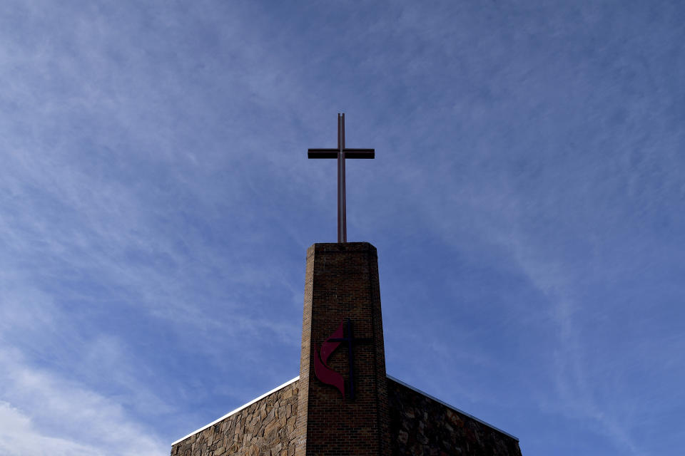CORRECTS SPELLING OF CHURCH TO CALVARY - A cross at the Calvary United Methodist Church about a mile from Club Q in Colorado Springs, Colo., on Wednesday, Nov. 23, 2022. The church stood in solidarity with the gay nightclub after a gunman opened fire and killed five people there Saturday night. (AP Photo/Thomas Peipert)