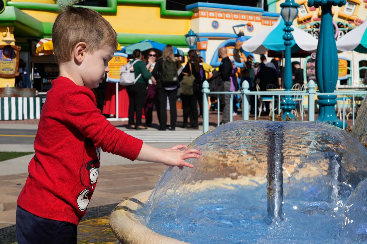 Grant Williams, 3, plays at a new fountain in Mickey’s Toontown at Disneyland. Guests are encouraged to touch the fountain that has water tables and is designed for a sensory experience.