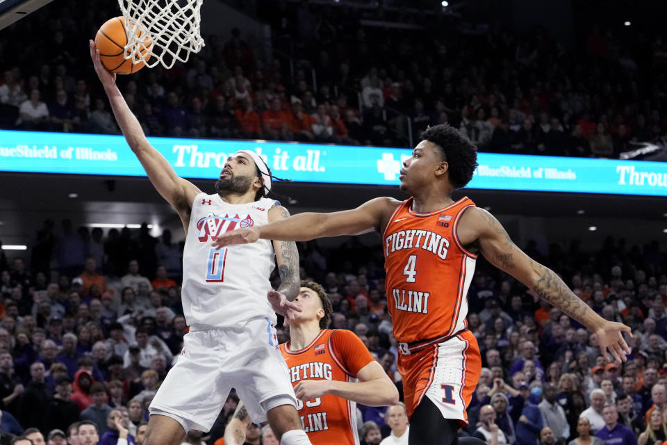 Northwestern guard Boo Buie, left, drives to the basket past Illinois guard Justin Harmon during the overtime in an NCAA college basketball game in Evanston, Ill., Wednesday, Jan. 24, 2024. (AP Photo/Nam Y. Huh)