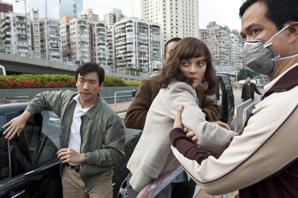 Chin Han, left, as Sun Feng and Marion Cotillard, center, as Dr. Leonora Orantes in the thriller "Contagion," a Warner Bros. Pictures release. (Claudette Barius/Warner Bros. Pictures/MCT)