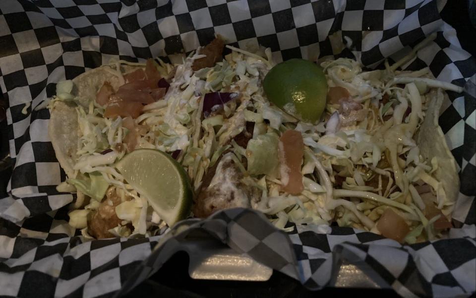 The fish tacos ($8) from Dia de los Pescados food truck are crunchy, with beer-battered fish and cabbage slaw.