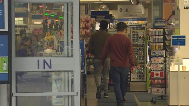 Customers enter the Granville Street London Drugs in downtown Vancouver, which reopened Sunday for the first time since a cyberattack hit the company.