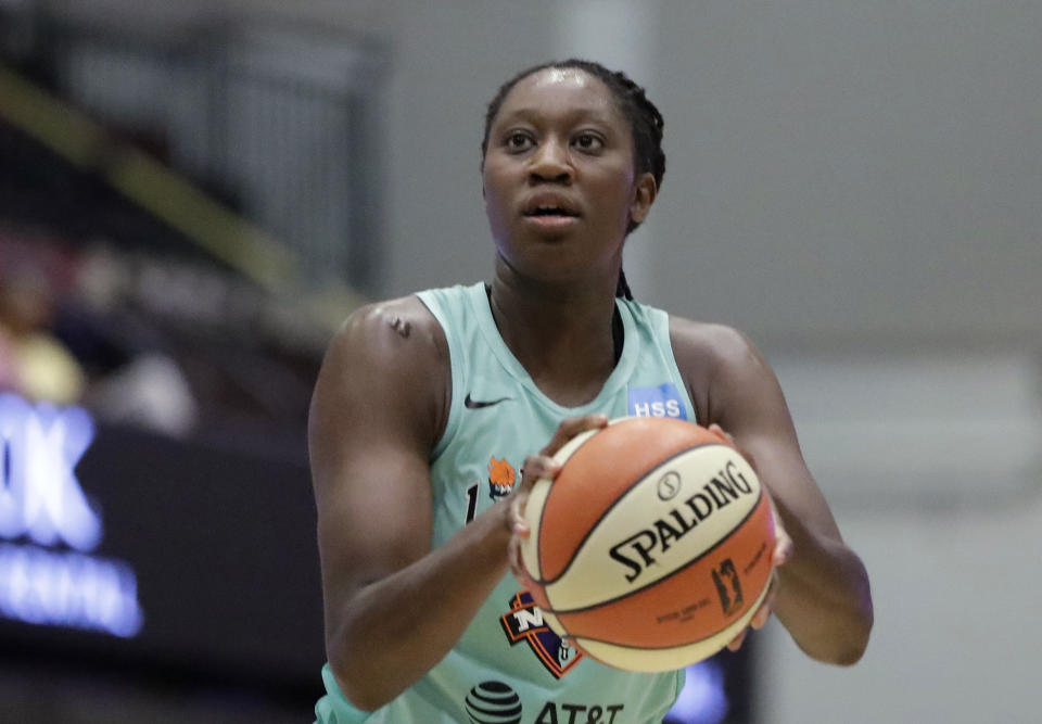 FILE - In this Aug. 13, 2019, file photo, New York Liberty center Tina Charles shoots a free throw during the first half of a WNBA basketball game in White Plains, N.Y. Charles, now with the Washington Mystics, is waiting to have her case heard by the league's independent panel of doctors to see if she'll be medically excused for the season. (AP Photo/Kathy Willens, File)