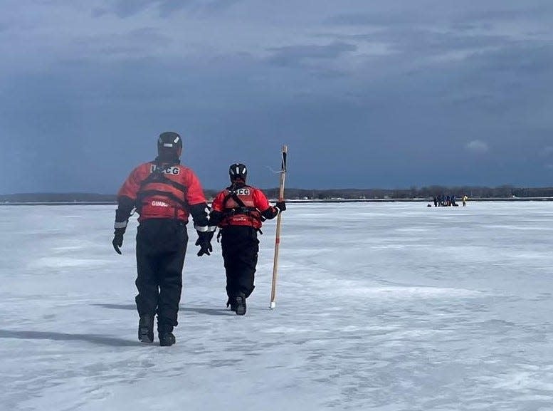 Members of the U.S. Coast Guard ice rescue team stationed in Sturgeon Bay head onto an ice floe in the bay of Green Bay to rescue six ice fishermen, seen in the distance at right, who were stranded on the floe when it broke away from shore April 2 off the Town of Gardner in Door County.