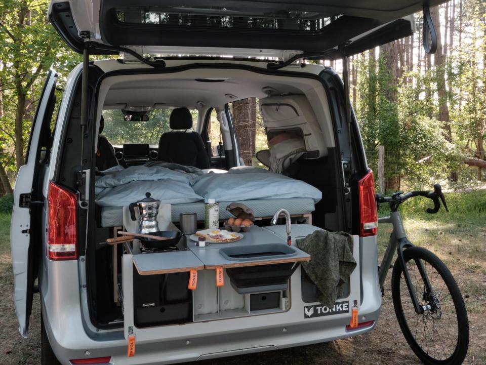 The rear kitchen with a bike next to the van.