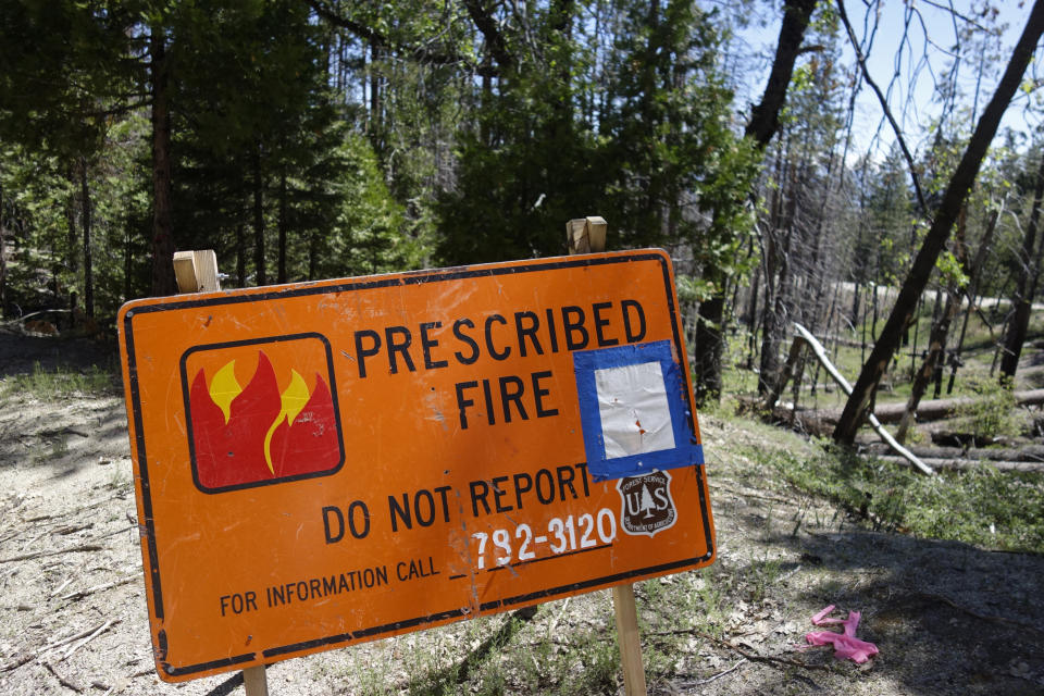 In this June 12, 2019 photo, a sign for a prescribed burn in the Giant Sequoia National Monument, Calif., remains posted two years after the fire. The prescribed burn, a low-intensity, closely managed fire, was intended to clear out undergrowth and protect the heart of Kings Canyon National Park from a future threatening wildfire. The tactic is considered one of the best ways to prevent the kind of catastrophic destruction that has become common, but its use falls woefully short of goals in the West. (AP Photo/Brian Melley)