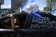 Demostrators celebrate in front of the Electoral Supreme Court in Guatemala City on September 3, 2015, as ex-president Otto Perez appeared in court over corruption allegations