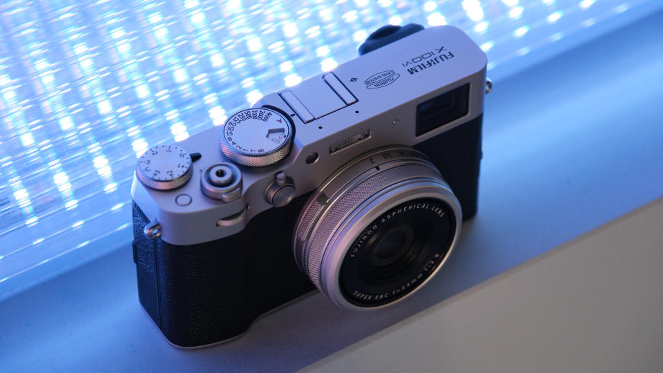 Fujifilm X100VI camera in front of a purple blue light