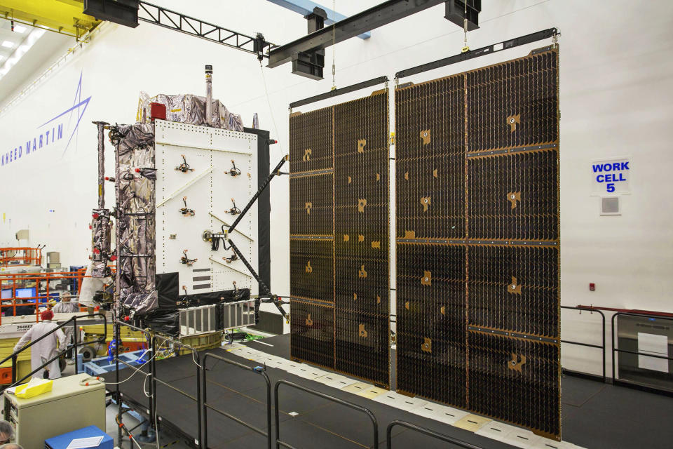 This June 23, 2017 photo provided by Lockheed Martin shows the second GPS III satellite during testing of the deployment of its solar arrays in a clean room at Lockheed Martin's complex south of Denver. The first GPS III satellite is scheduled to be launched from Cape Canaveral, Fla., on Tuesday, Dec. 18, 2018. (Pat Corkery/Lockheed Martin via AP)