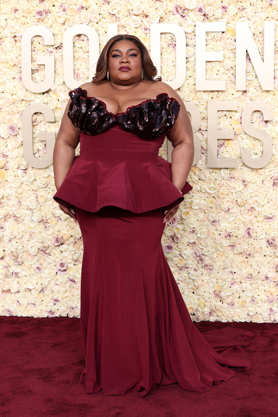 Da’vine Joy Randolph wearing Rodarte red dress on red carpet at Golden Globes.
