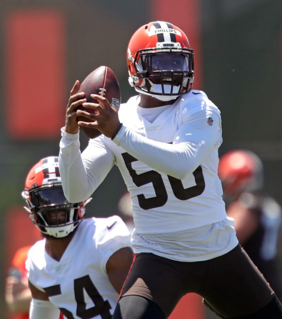 Cleveland Browns linebacker Jacob Phillips (50) catches a ball during drills during an NFL football practice at the team's training facility, Wednesday, June 16, 2021, in Berea, Ohio.