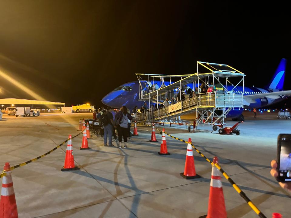 Passengers walk from the Vero Beach Municipal Airport terminal to the Breeze Airways plane bound for Hartford, Connecticut on Saturday, March 18, 2023.