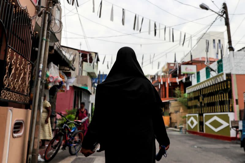 FILE PHOTO: A Muslim woman wearing a hijab walks through a street near St Anthony's Shrine in Colombo