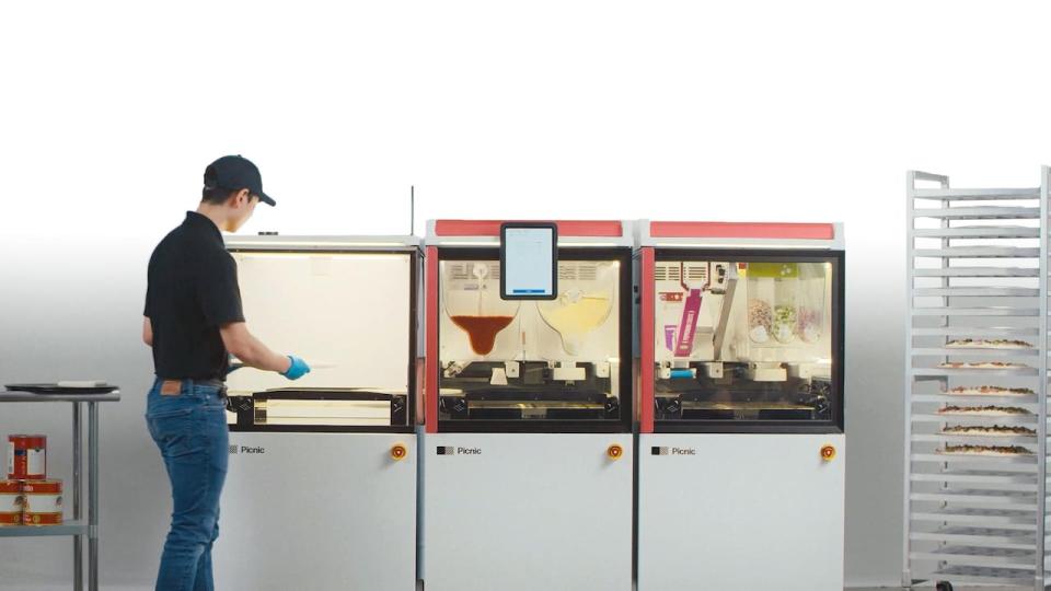 Domino's is experimenting with a pizza assembly machine manufactured by a startup called Picnic at one of its locations in Berlin, Germany. 