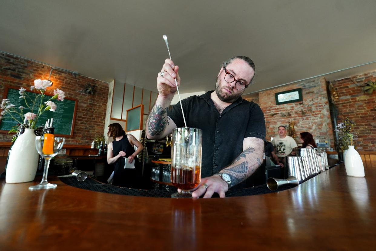 Co-owner and bartender Josh Miller prepares a cocktail, at Longfellow in Over-the-Rhine, one of USA TODAY's Bars of the Year.